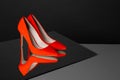 Pair of lady`s shoes on table against black background