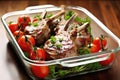 a pair of lamb chops in a baking dish