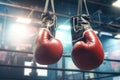 Pair of Leather Boxing Gloves Hanging in a Gym: Concept for Strength Training, Competitive Sports, and Boxing Equipment -