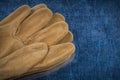 Pair of leather brown protective gloves on scratched metallic su Royalty Free Stock Photo