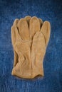 Pair of leather brown working gloves on scratched Royalty Free Stock Photo