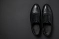 Pair of leather men shoes on black background, top view. Space for text Royalty Free Stock Photo