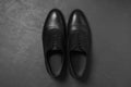 Pair of leather men shoes on grey surface, top view Royalty Free Stock Photo