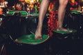 Pair of legs in black stockings on a green chair.