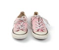 Pair of light pink worn textile sneakers with laces isolated on a white background