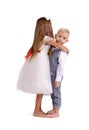 Cute, fancy, charming brother and sister isolated on a white background. Little boy and girl hugging. Family concept. Royalty Free Stock Photo