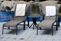 A pair of lounge chairs by a pool Royalty Free Stock Photo