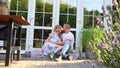 Pair of lovers sitting in garden in backyard.