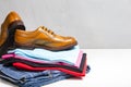 Pair of Male Full Brogued Tan Oxford Shoes Placed on Top of Heap Of Clothing