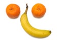 A pair of mandarin oranges and a single banana arranged in the shape of a face Royalty Free Stock Photo