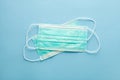 pair of medical surgical protective masks on pastel blue background