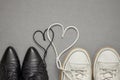 A pair of men`s sneakers and women`s shoes in love. Laces in the shape of a heart. Family and love concept. Valentines day Royalty Free Stock Photo