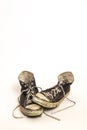 Pair of Men`s or Teenager`s Worn Out Grungy Dirty High Top Black and White Tennis Shoes on on White Background Royalty Free Stock Photo