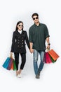 A pair of men and women wore glasses and carried lots of paper bags for shopping