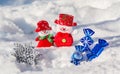 A pair of merry snowmen in the snow with Christmas toys with blue candies and a silvery snowflake. Merry Christmas and Happy New