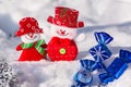 A pair of merry snowmen in the snow with Christmas toys with blue candies and a silvery snowflake. Merry Christmas