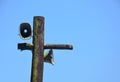 Pair of metal old vintage horn speaker for public relations on wood post covered with green moss and lichen Royalty Free Stock Photo