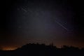 Pair of Meteors. Meteor Shower Night Sky with Landscape Silhouette Royalty Free Stock Photo