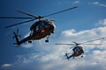 Pair of military helicopters perform thrilling maneuvers in azure skies