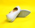 Pair of milk blue  female summer shoe on yellow background Royalty Free Stock Photo