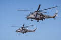 Pair of modern Russian attack helicopters MI-35M perform demonstration flights in the sky over a military training ground Royalty Free Stock Photo