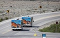 Pair of Motor Homes travelling on the Icefield Parkway in front of large glacier in Jasper National Park, Alberta, Canada