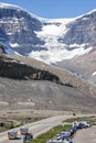 Pair of Motor Homes travelling on the Icefield Parkway in front of large glacier in Jasper National Park, Alberta, Canada