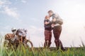 A pair of motorcyclists kiss, kissing. Guy and girl. Loving couple of tourists. Relationship and adventure concept. A motorcycle