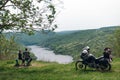 A pair of motorcyclists, man and woman. Loving couple of tourists. Relationship and adventure concept. A motorcycle with luggage,