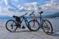 Pair of mountain bikes standing on the Black sea pier on scenic seaside background