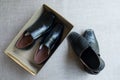 New black leather shoes inside box and pair old black leather shoes outside box Royalty Free Stock Photo