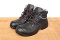 Pair of new black work boots made of genuine leather with a reinforced cape, the concept of special shoes for different Royalty Free Stock Photo