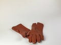 A pair of new brown leather gloves isolated on a white background. Graceful women's brown leather gloves on a white Royalty Free Stock Photo