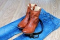 Leather brown cowboy boots and belt on blue jeans Royalty Free Stock Photo