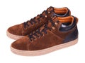 Pair of new modern brown suede stylish sneakers for men on laces isolated Royalty Free Stock Photo