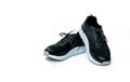 Pair of new running shoes on white background. Black sneakers. Breathable fabric sport shoes with high abrasion rubber