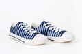 Pair of new, trendy striped navy blue and white sneakers on white background Royalty Free Stock Photo