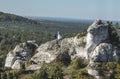 A pair of newlyweds during a photo session on the rocks against the background of an interesting landscape in Podlesice in the Royalty Free Stock Photo