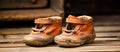 Pair of old baby shoes resting on hardwood flooring Royalty Free Stock Photo