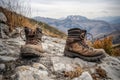 pair of old boots on a rocky mountain trail, adventure