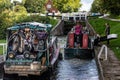Pair of old canal boats navigating the Caen Hill flight of locks on the Kennet & Avon Canal in Devizes, Wiltshire, UK