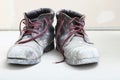 Pair of old dirty work boots in building site Royalty Free Stock Photo