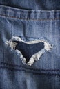 Pair of old jeans with heart shaped rip Royalty Free Stock Photo