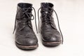 Pair of old leather black hipster boots Royalty Free Stock Photo