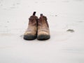 Pair old leather boots on sand Royalty Free Stock Photo