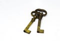 A pair of old oxidized brass keys isolated on a white background