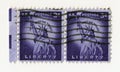 A pair of old purple vintage american postage stamps with the statue of liberty in Manhattan