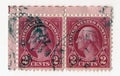 A pair of old red vintage american postage stamps with the image of George Washington