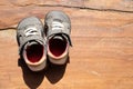 A pair of old shoes a brown wooden board. Royalty Free Stock Photo