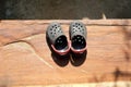 A pair of old shoes a brown wooden board. Royalty Free Stock Photo